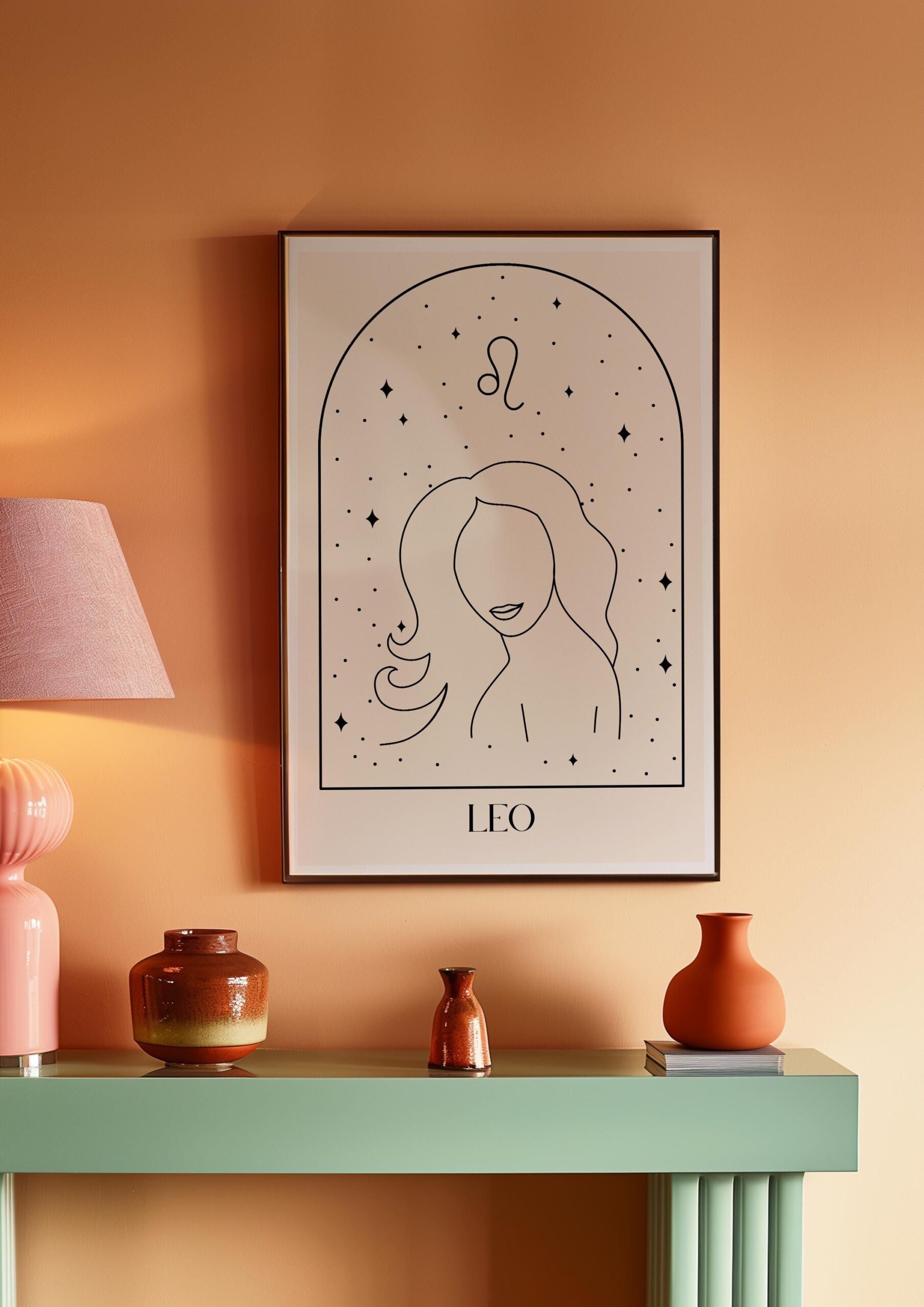 A framed line art print of a woman's face, with the Leo zodiac symbol and text, hanging above a green console table.
