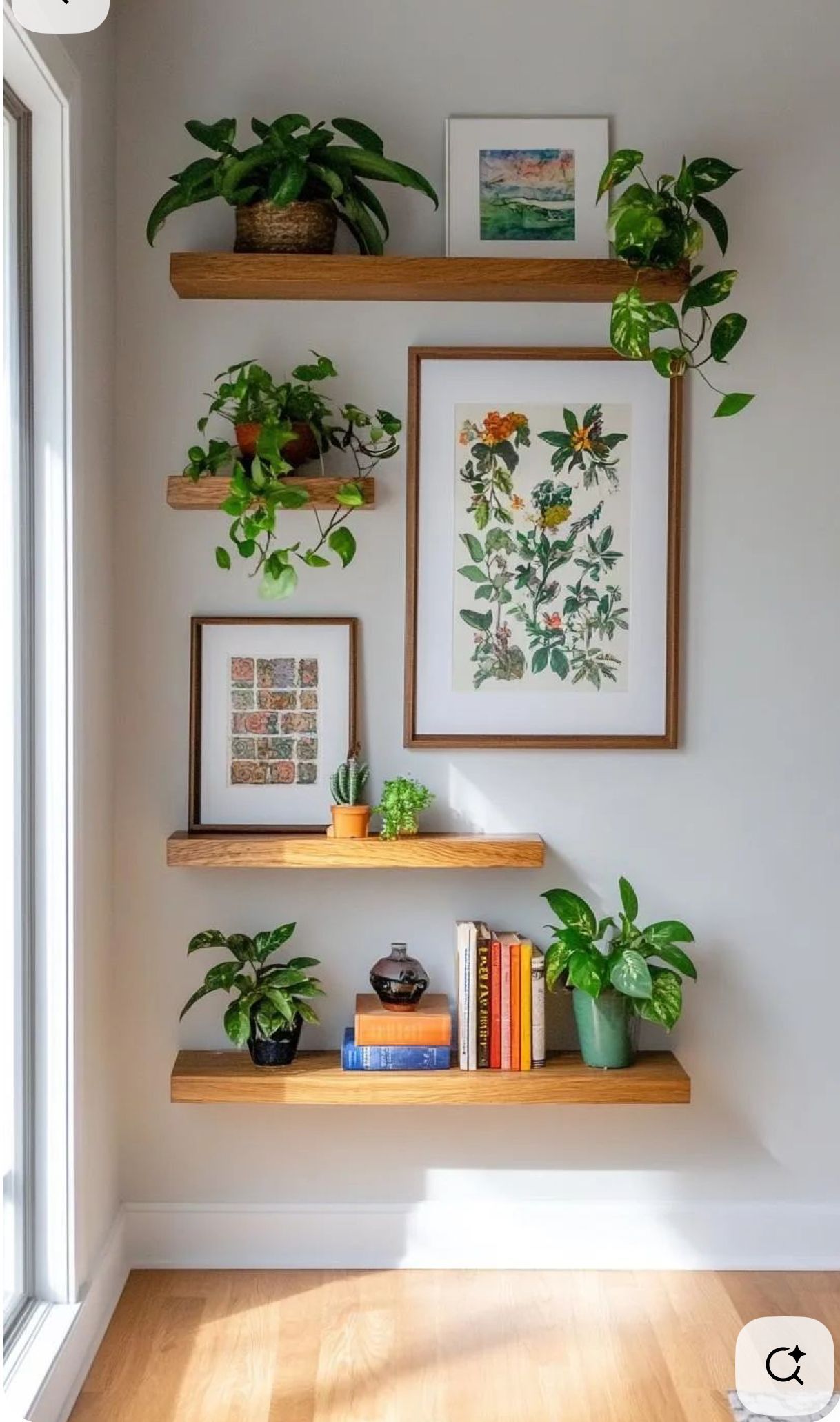 Floating natural wood shelves displaying potted plants, framed botanical prints, books, and decorative objects on a…