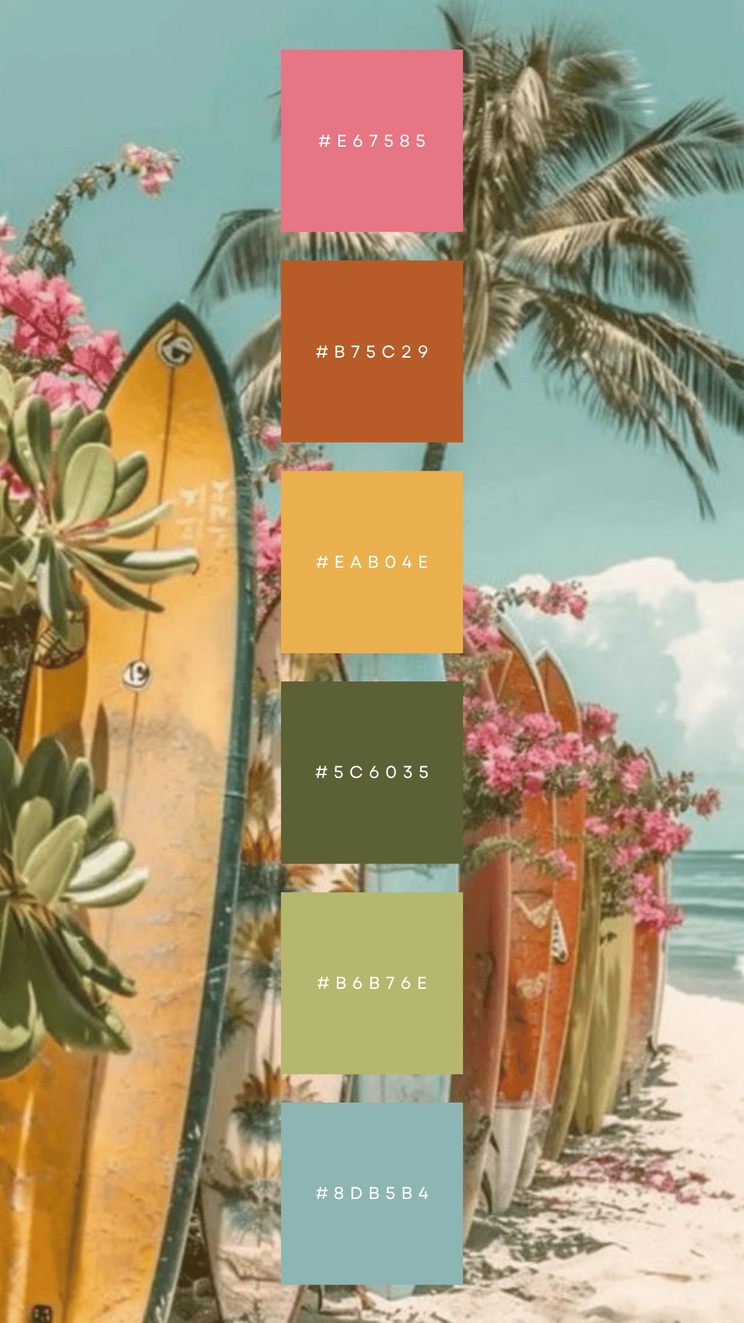 Surfboards on a sandy beach with palm trees and pink flowers behind them.