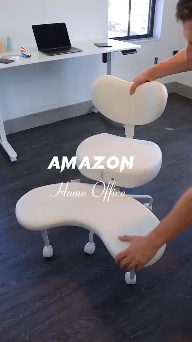 Person adjusting a white ergonomic office chair with a split, curved seat designed for cross-legged sitting