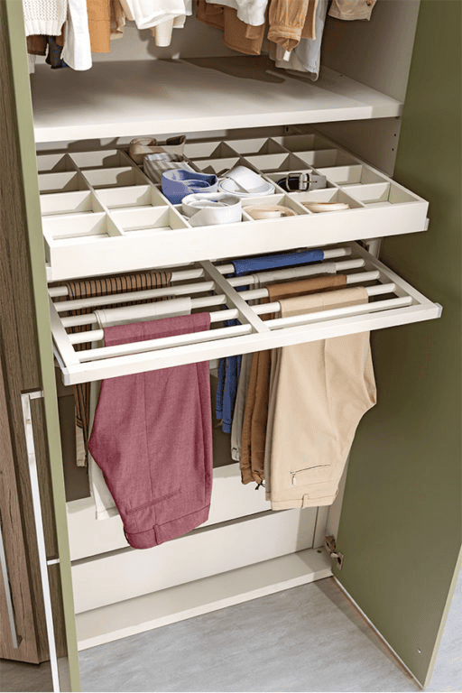 Pull-out closet organizers with divided tray for ties and belts, and a hanging rack for pants.