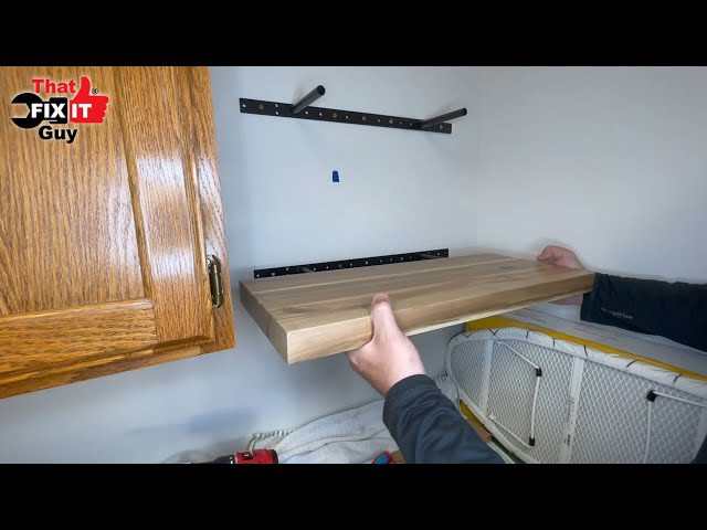 Wall-mounted shelf pulling away from drywall near its mounting screws