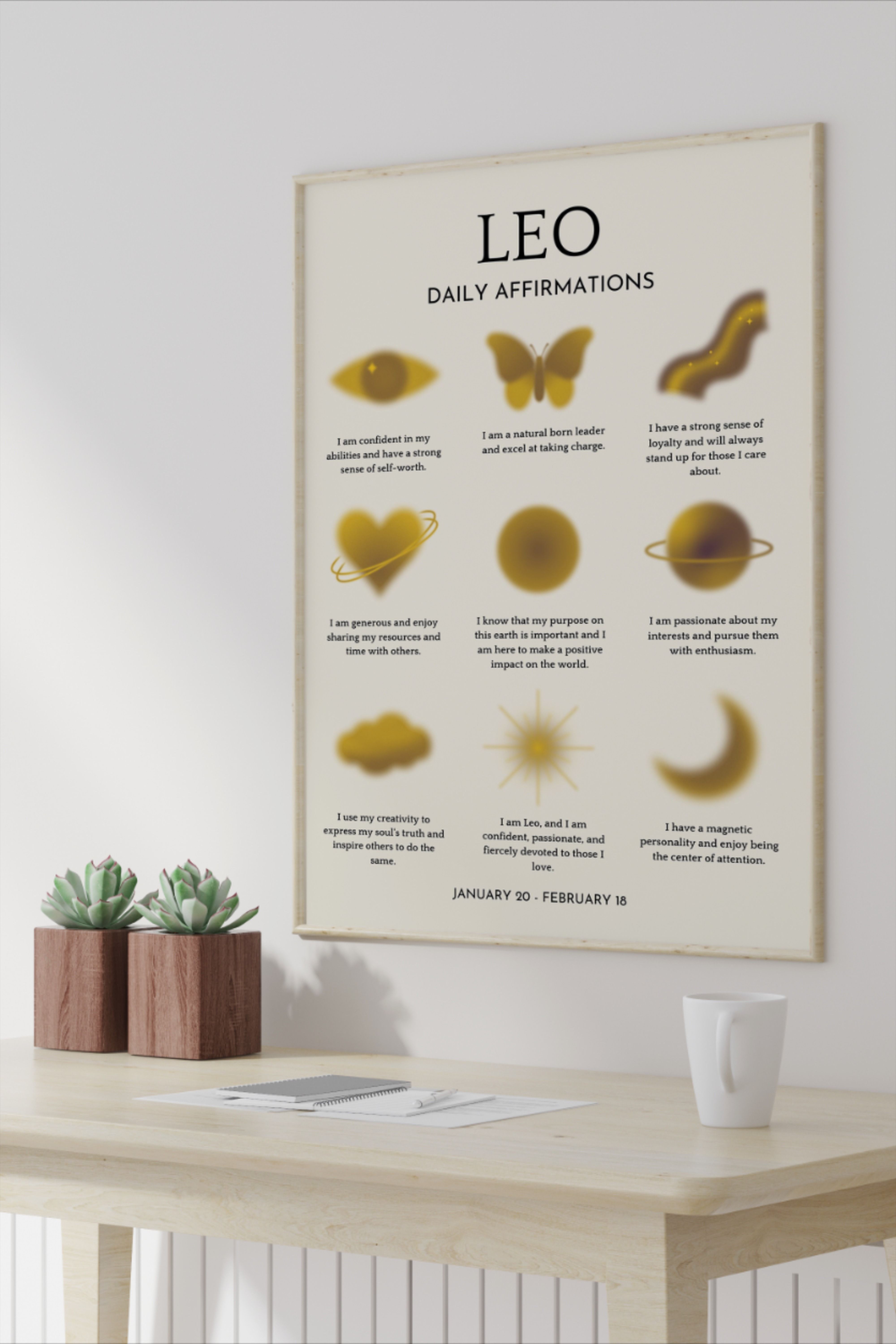 A framed 'Leo Daily Affirmations' poster with golden abstract symbols hangs above a light wood desk with two small succulent…