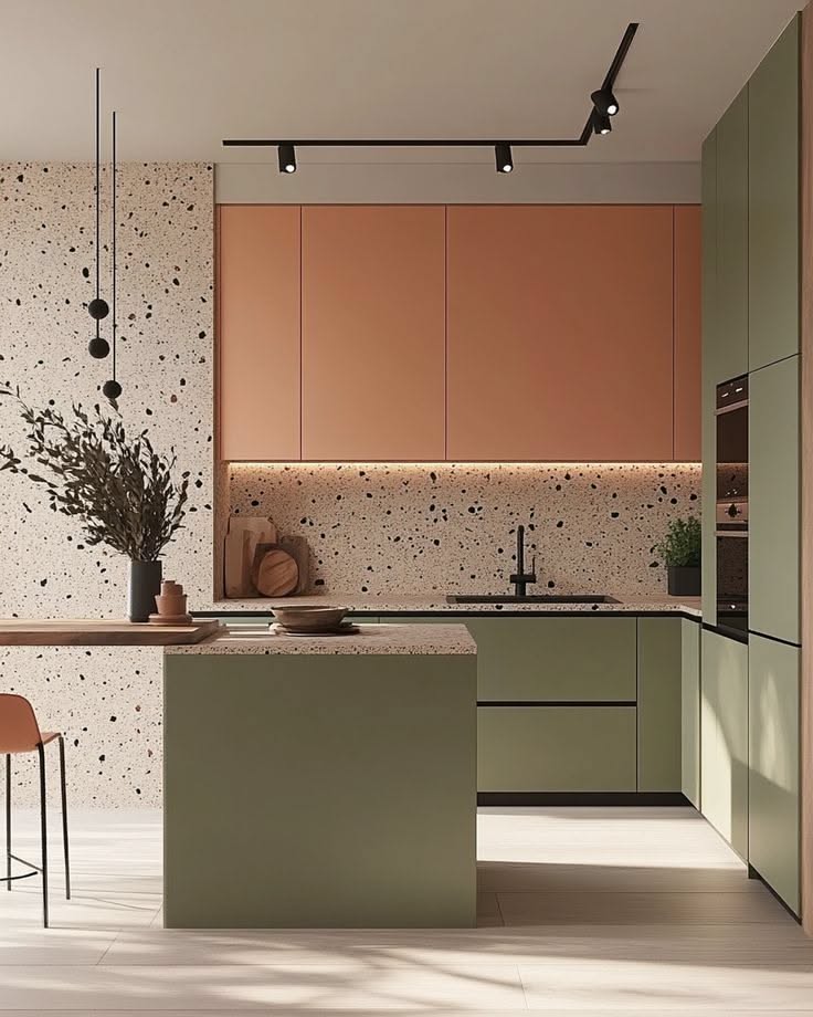 Modern kitchen with terrazzo backsplash, olive green lower cabinets, and terracotta-colored upper cabinets.