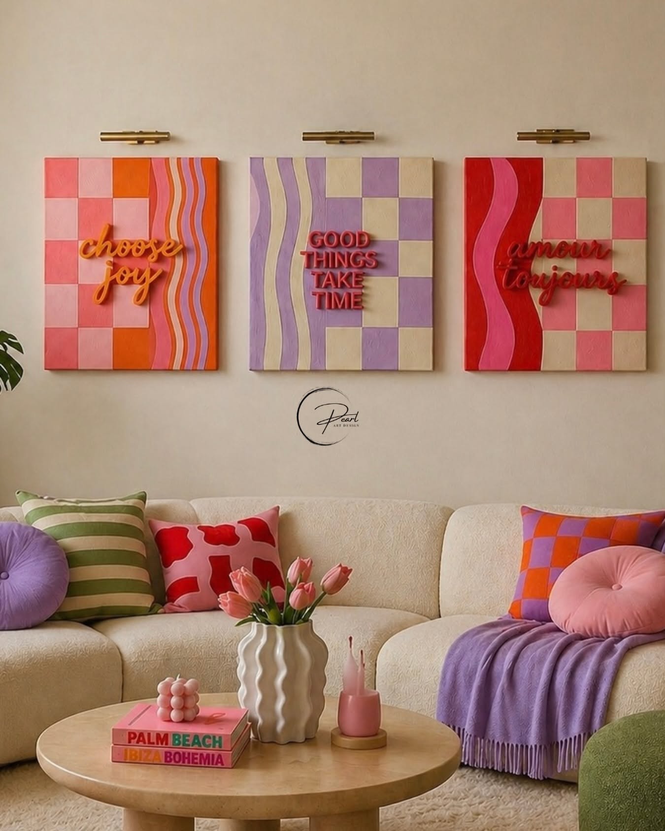 A beige sofa with colorful pillows and a purple throw blanket. Above the couch are three square art pieces with checkerboard…