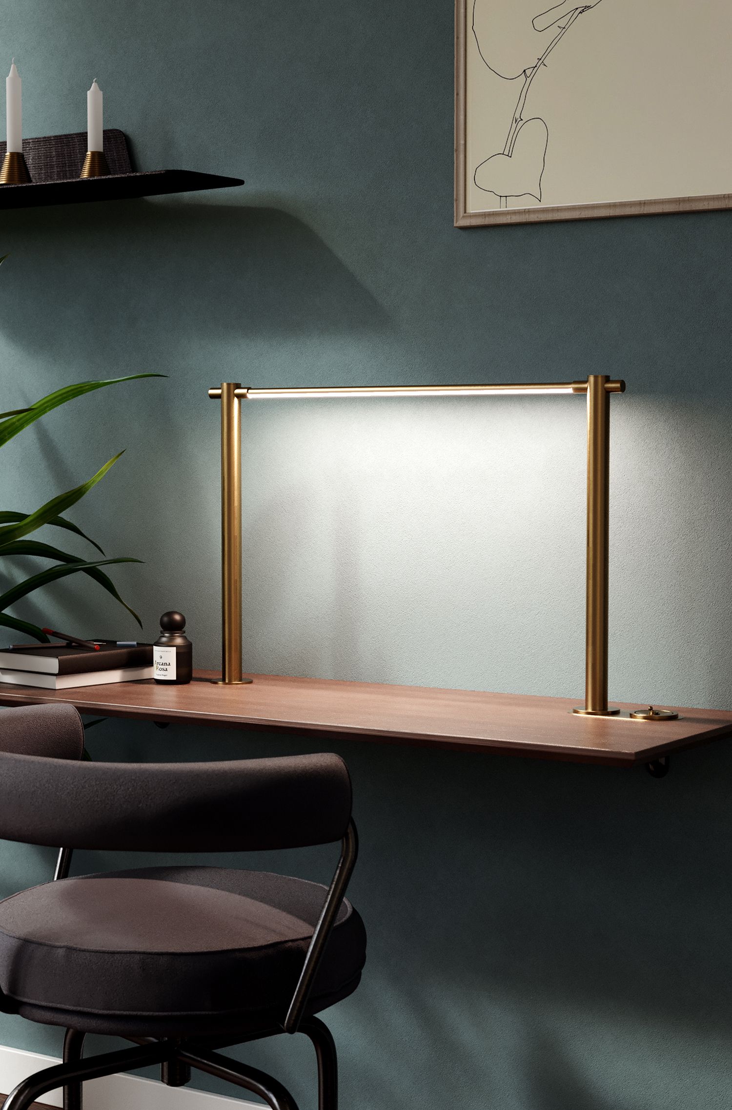 Desk with a gold, rectangular-shaped task lamp emitting white light, next to a plant and notebooks.