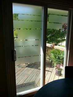 Sliding glass door with horizontal frosted stripes covering most of the glass