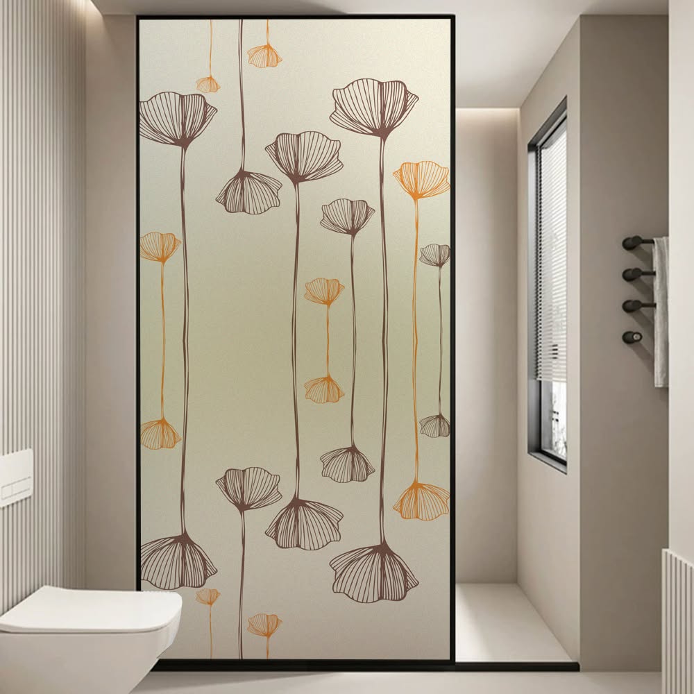 Frosted glass film with a floral pattern applied to a shower door in a modern bathroom.