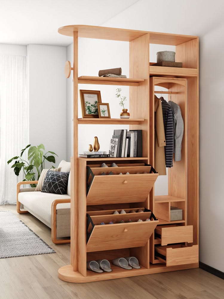 Wood multi-functional entryway unit with shelves, shoe storage, closet space, and drawers next to a couch.