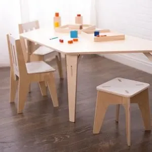 Light wood children's activity table with two chairs and one stool, holding small wooden trays with building blocks.