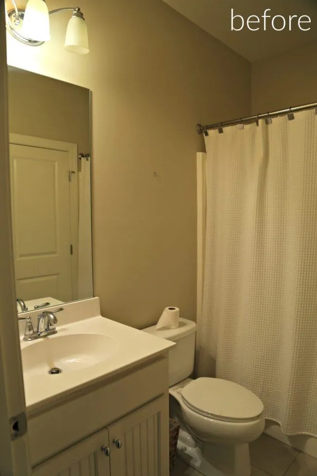 Standard beige bathroom with a vanity, mirror, toilet, and shower curtain. Text overlay reads 'before'.