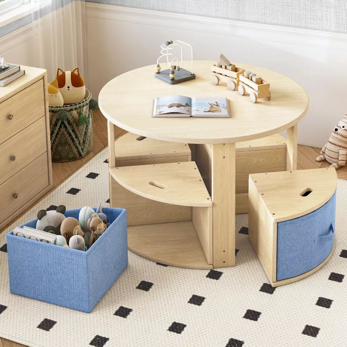 Round light wood activity table with three wedge-shaped stools, two of which have blue fabric storage bins.