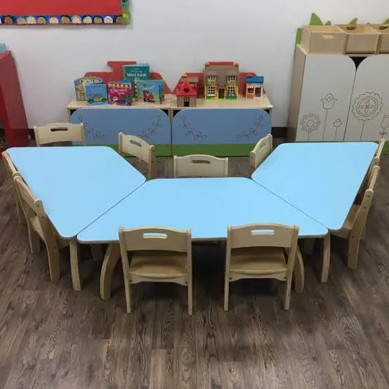 Several light blue and wood toddler-sized tables arranged in a hexagonal shape with matching chairs