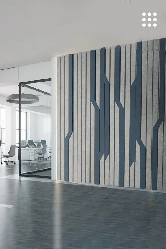 Close-up of a modern office wall featuring vertical sound-absorbing panels in alternating light gray and dark blue with a…