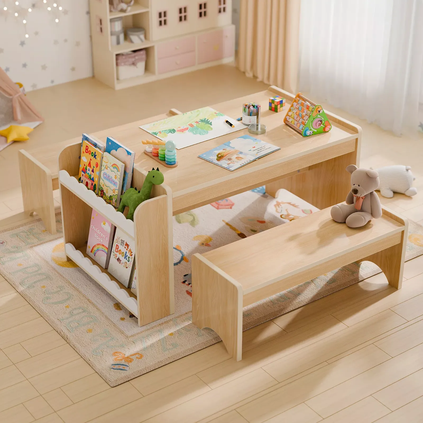 Wooden activity table with matching bench and separate book storage unit. The table is set up with art supplies and books.