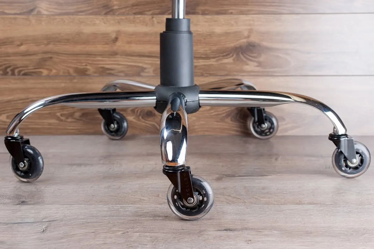 Office chair base with five clear, soft-material caster wheels resting on a light wood floor.